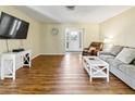 Spacious living room featuring sleek laminate floors, neutral walls, and ample natural light at 3560 Sandpiper Ln, Mulberry, FL 33860