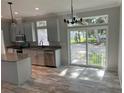 Modern kitchen featuring stainless steel appliances, granite counters, and access to the backyard at 3780 Pioneer Trails St, Lakeland, FL 33810