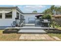 Spacious backyard deck with a seating area and grill, perfect for outdoor entertaining at 3854 Feather Dr, Lakeland, FL 33812