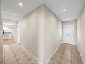 Bright foyer with neutral walls, tile flooring, and decorative front door at 4230 Viola Rd, Lakeland, FL 33810