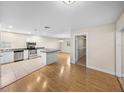 Open concept kitchen with stainless steel appliances and light countertops at 4230 Viola Rd, Lakeland, FL 33810