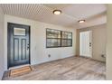 Inviting covered porch area showcasing tile flooring, a 'Welcome Home' mat, and ample natural light at 4622 Grovecrest Dr, Lakeland, FL 33813