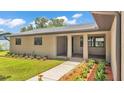 Charming covered front porch with stylish columns, beautiful landscaping, and a welcoming entrance at 4622 Grovecrest Dr, Lakeland, FL 33813