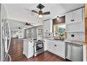 Beautiful kitchen with modern white cabinets, stainless steel appliances, and eat-in island at 504 Prado Pl, Lakeland, FL 33803