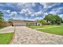 Attractive single-Gathering home with a brick paver driveway, lush lawn, and manicured landscaping at 5313 Nichols W Dr, Lakeland, FL 33812