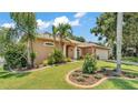 Inviting home exterior with lush landscaping and a well-maintained lawn at 5548 Woodwind Hills Dr, Lakeland, FL 33812