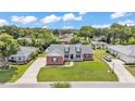 Aerial shot showcasing the home, front lawn, and the property's well-manicured landscaping at 5579 Summerland Hills Dr, Lakeland, FL 33812