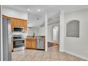 Well-equipped kitchen with stainless steel appliances, granite countertops, tile flooring, and ample storage space at 577 Majestic Gardens Blvd, Winter Haven, FL 33880