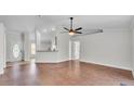 Bright and open living room featuring hardwood floors, neutral walls, providing a comfortable living space at 577 Majestic Gardens Blvd, Winter Haven, FL 33880