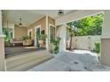 Cozy front porch features a swing, seating, decorative tile steps, and a view of the carport at 608 Finney St, Lakeland, FL 33803