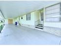 Covered parking area with stairs leading to front door at 622 Elizabeth Ln, Lakeland, FL 33809