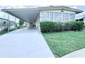 View of home with covered parking and manicured front lawn at 622 Elizabeth Ln, Lakeland, FL 33809
