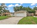 Charming single-story home featuring an attached two-car garage and a well-maintained front yard at 6406 Butternut Dr, Lakeland, FL 33813