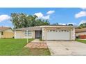 Charming single-story home featuring an attached two-car garage and a well-maintained front yard at 6406 Butternut Dr, Lakeland, FL 33813