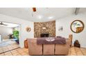 Inviting living room with a stone fireplace and neutral decor at 6421 Calusa Dr, Lakeland, FL 33813