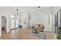 Bright living room with high ceilings, wood floors, and arched doorways at 6707 Hillis Dr, Lakeland, FL 33813