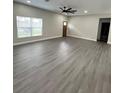 The light and bright living room boasts sleek floors, a large window, and an open layout at 801 Robson W St, Lakeland, FL 33805