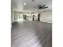 Open-concept living room with recessed lighting, fan, and sliding glass doors at 801 Robson W St, Lakeland, FL 33805