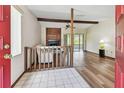 Inviting living room featuring a fireplace, wood floors, ceiling fan, and access to the sunroom at 849 Rockingham Rd, Lakeland, FL 33809