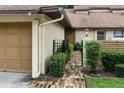 Inviting townhome exterior showcasing a brick pathway leading to the front door and lush greenery at 925 Fenton Ln # 18, Lakeland, FL 33809