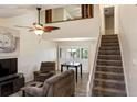 Bright living room features a vaulted ceiling, fan, stairs, and natural light at 925 Fenton Ln # 18, Lakeland, FL 33809