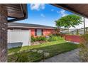 Private backyard showcasing lush landscaping, a white fence, and a charming outdoor space at 1523 Mariner Rd, Lakeland, FL 33803