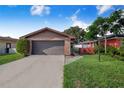 Charming home featuring a brick facade, well-maintained landscaping, and a two-car garage at 1523 Mariner Rd, Lakeland, FL 33803
