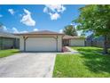 Single-story home with a two-car garage, well-maintained lawn, and inviting curb appeal at 1081 Sunshine Sw Way, Winter Haven, FL 33880
