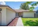 A walkway leads to the front door of the house, complemented by meticulously arranged landscaping at 1081 Sunshine Sw Way, Winter Haven, FL 33880