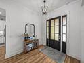 Welcoming entryway featuring wood floors, stylish lighting, and decor at 128 Melissa Trl, Auburndale, FL 33823