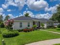 Well-maintained home with lush landscaping, colorful flowers and a manicured lawn at 128 Melissa Trl, Auburndale, FL 33823