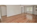 Spacious living room with hardwood floors and neutral walls, featuring an arched doorway at 132 Kinstle Ave, Auburndale, FL 33823