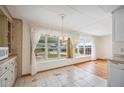 Bright dining area featuring large windows and a decorative chandelier fixture at 1610 Reynolds Rd # 214, Lakeland, FL 33801