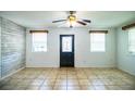 View of the bright living room featuring fresh paint, tile floor, and two large windows at 1720 Park Dr, Lakeland, FL 33803
