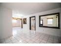 Open living area features bright white tile flooring, fresh paint, and natural light at 1720 Park Dr, Lakeland, FL 33803