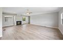 Bright living room boasts a cozy fireplace, natural light, and ceiling fan at 2055 S Floral Ave # 245, Bartow, FL 33830