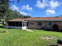A spacious backyard with a screened porch offers outdoor relaxation at 2105 E Cherokee St, Bartow, FL 33830