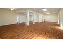 Spacious open-concept living room with wood flooring, ceiling fans, recessed lighting, and natural light at 2219 Starboard Rd, Winter Haven, FL 33881