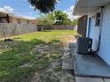 Large backyard features grassed area, and mature trees at 225 W Orange St, Lake Alfred, FL 33850