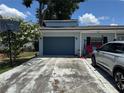 This home features an attached one car garage and long concrete driveway for ample parking at 225 W Orange St, Lake Alfred, FL 33850