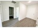 Open-concept living space with wood-look flooring and neutral paint throughout at 2521 Sunset Dr, Winter Haven, FL 33881