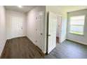 Bright room with wood-look floors, white walls, and windows at 2521 Sunset Dr, Winter Haven, FL 33881