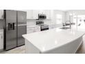 Modern kitchen with stainless steel appliances, white cabinetry, and an island at 3167 Laurel Oak Ln, Winter Haven, FL 33884