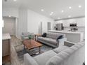 Open-concept living area with neutral tones and a seamless flow into the kitchen at 3167 Laurel Oak Ln, Winter Haven, FL 33884
