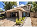 Home featuring covered parking, a welcoming front entrance, and a neatly landscaped walkway at 3542 Raintree Ct, Lakeland, FL 33803