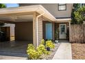 Inviting home with covered parking, showcasing a quaint front walkway and an eye-catching blue entrance at 3542 Raintree Ct, Lakeland, FL 33803
