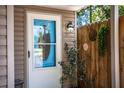 Charming home entrance with decorative door, sidelight, stylish light fixture, and artful fence detail at 3542 Raintree Ct, Lakeland, FL 33803