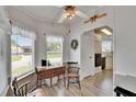 Cozy dining area featuring wood-look floors and lots of natural light at 451 Village Sw Cir, Winter Haven, FL 33880