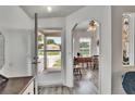 Bright foyer featuring wood-look flooring and an open view to the outdoors at 451 Village Sw Cir, Winter Haven, FL 33880