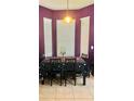 Cozy dining area featuring a table with unique table setting, a pendant light, and a large window at 4665 Sw 40Th Pl, Ocala, FL 34474
